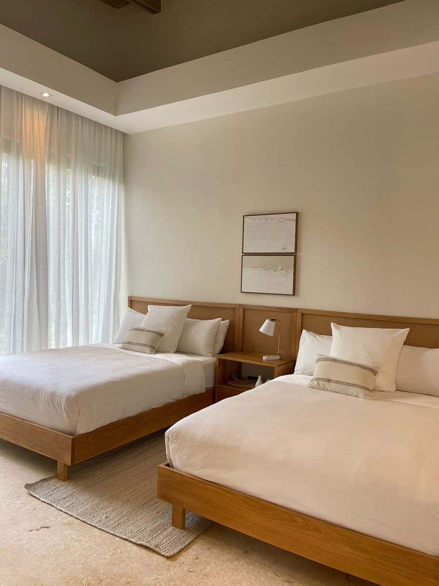 A guest-ready bedroom with two freshly made beds in crisp white linens